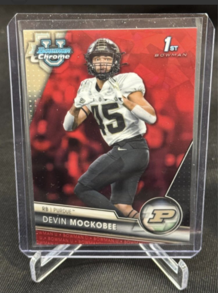 BrianPeloza's tweet photo. @cmockobee hello! Do you happen to have more than one of Devin’s red shimmer card from 2023 that looks very similar to this one? It’s numbered out of 5. The last one I need from that year outside of the 1/1 cards. Thanks https://t.co/Ke1gBYAKqe