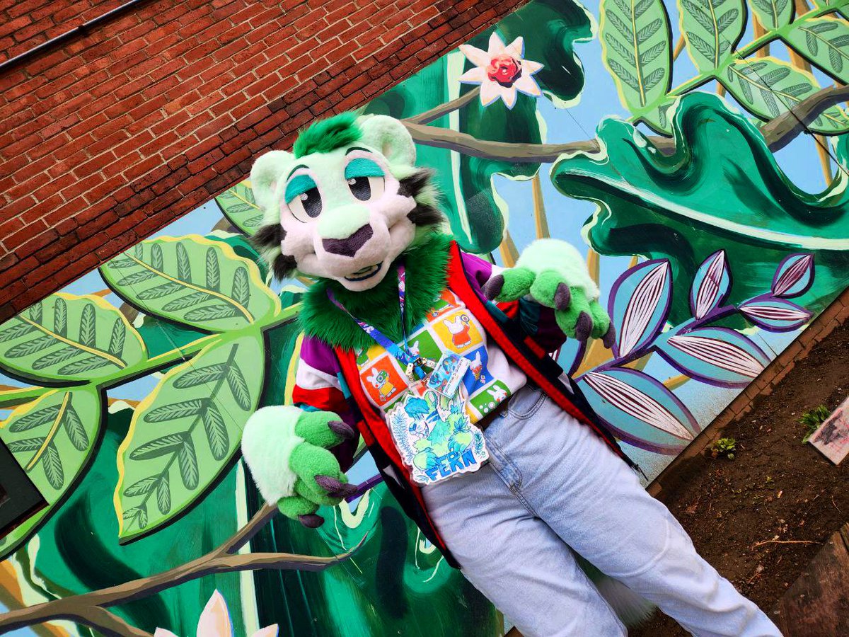 SockCorgi's tweet photo. ✧･ﾟ: *✧ If you saw me, a stranger in the streets, could you tell me you love me? ✧･ﾟ: *✧

Happy #FursuitFriday 🌿 @edgar_undead_ noticed this mural in Portland at #FCL2025 and was kind enough to take photos of Fern in front of it 🌱 https://t.co/THZj3wzMVM