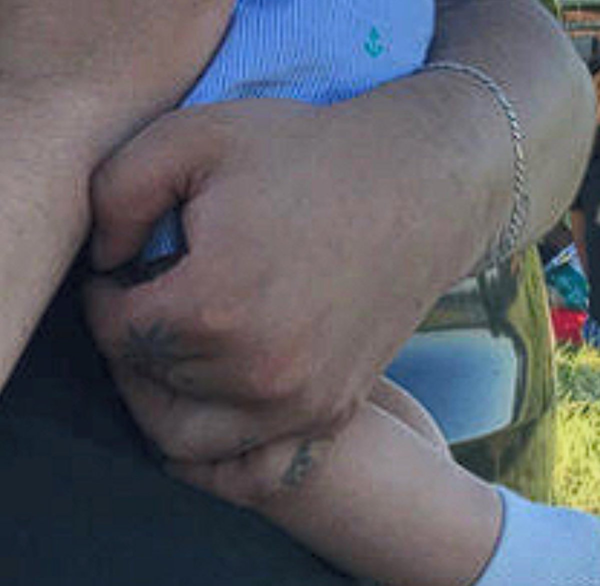 LarkinPeekay's tweet photo. @RapidResponse47 The Trump Administration is straight up lying to the public. The picture Trump is holding is photoshopped. Zoom in on the hand. The color of the ink is different.  The font is way too straight and crisp. And these pics of his actual hand don’t have the tattoos. This is criminal. https://t.co/x20lxhxKPn