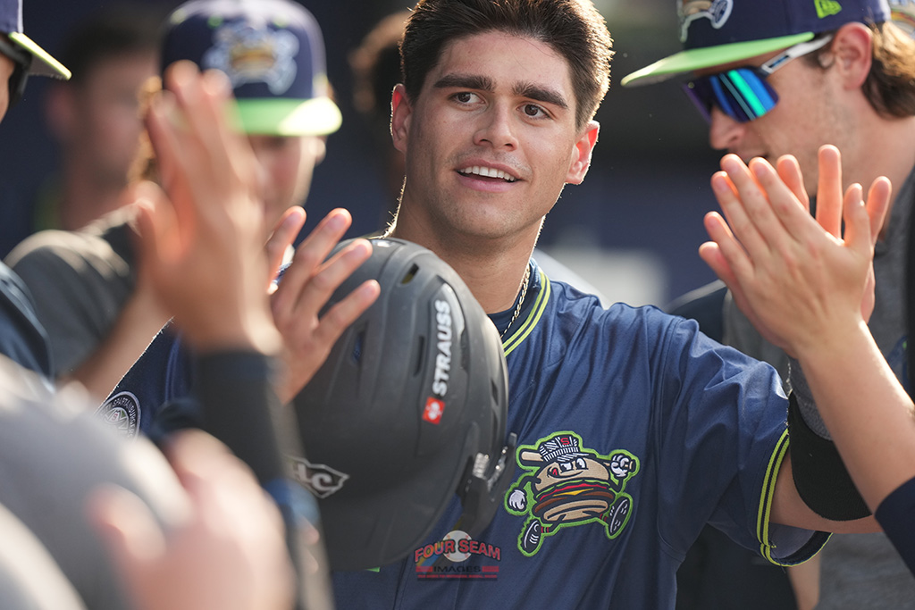 Julian Brock (31) of the Hub City Spartanburgers is greeted in the dugout after scoring a run in the third inning of a South Atlantic League game against the Bowling Green Hot Rods on Saturday, April 19, 2025, at Fifth Third Park in Spartanburg, S.C. (Tom Priddy/Four Seam Images)