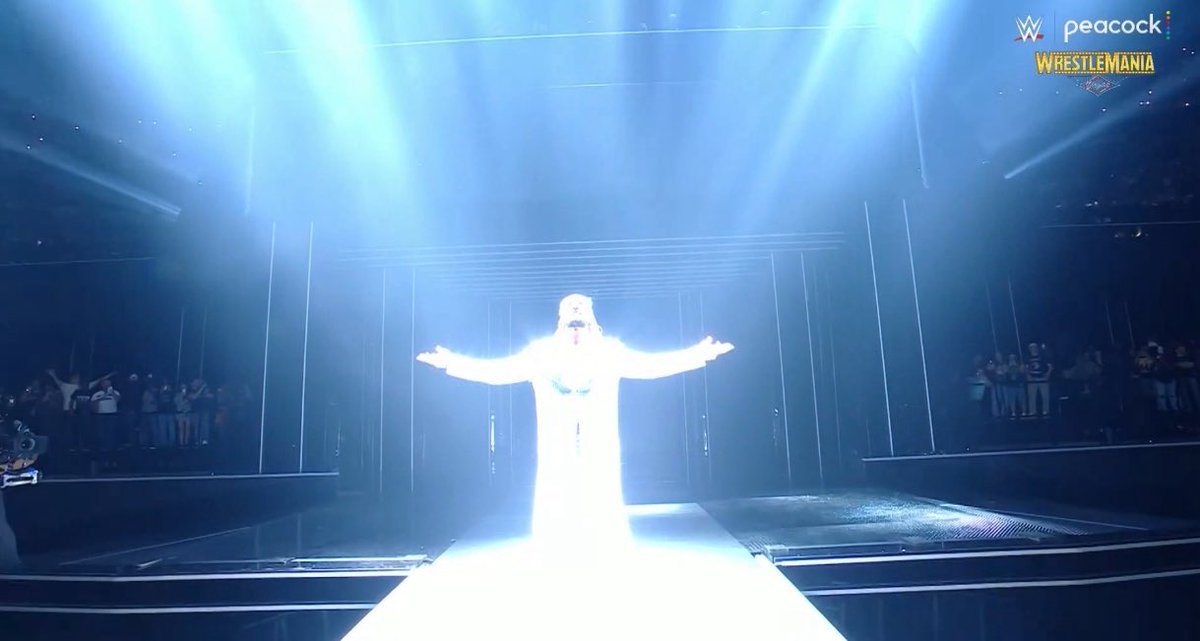 WRESTLEZONEcom's tweet photo. Seth Rollins used a flamethrower, then struck a Jesus pose in his entrance... and there's a crown of thorns around his glasses. 

#WrestleMania https://t.co/5xYDh5Nys9