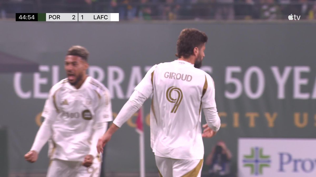 A screenshot from an Apple TV broadcast showing a soccer match with the scoreboard reading 44:54, POR 2, LAFC 1, featuring a player in a white jersey with 'GIROUD' and number 9 on the back, alongside another player and '50 YEARS' visible in the background.