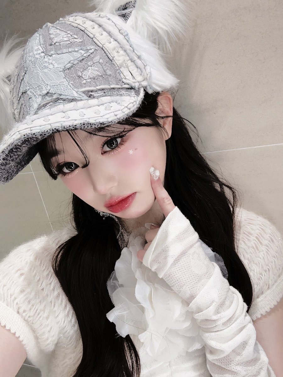 With  a  touch  as  light  as  a  butterfly’s  wing
she traces  the curve of her  cheek, where the 
stars in their generosity, have whispered their  
secrets,   the   fleeting   glow  lingering  like  a 
whisper   on   her   skin