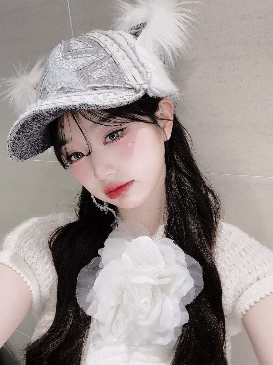 A silver-threaded  cap, crowned  with feathery 
tufts   as  delicate   as  a  sparrow's  wing,  sits  
perched   upon    her   cascading    tresses,   a
diadem  of  winter's   grace,  woven  with   the 
nostalgia   of     frost-laced     mornings     and whispered  lullabies