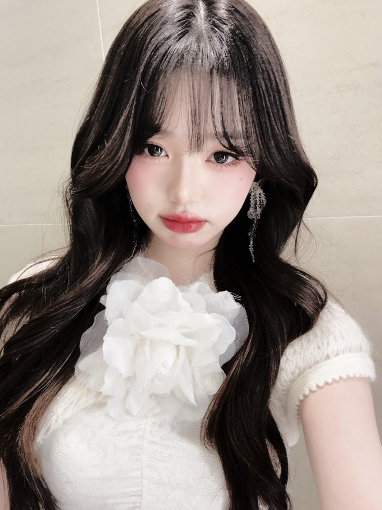 Her  eyes,  deep  pools  of  dusk  and  longing
hold the weight of a thousand unsung ballads
their haunting melodies woven  into the silken 
cascade  of  tresses that  frame  her porcelain 
skin