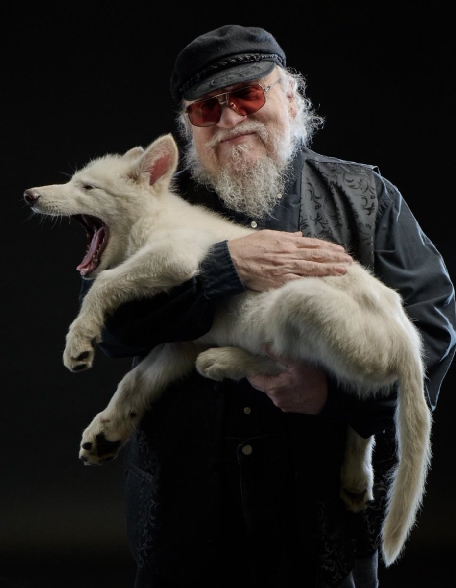TheJRECompanion's tweet photo. So fitting... George R.R. Martin holds the first Dire Wolf born in over 10,000 years. https://t.co/1L0mqCHH4e