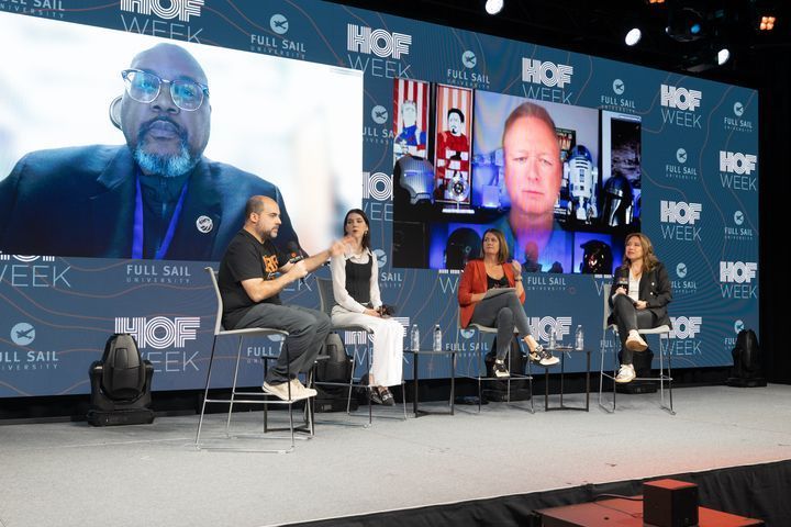 alexbratton's tweet photo. Event panel discussion formats are evolving. Had a chance to speak via Vision Pro to share spatial computing and #applevisionpro thoughts at Full Sail University’s Hall of Fame week (that’s my persona on the right side of the big screen). Want to watch? Video link in thread. https://t.co/cRvr75MRUi