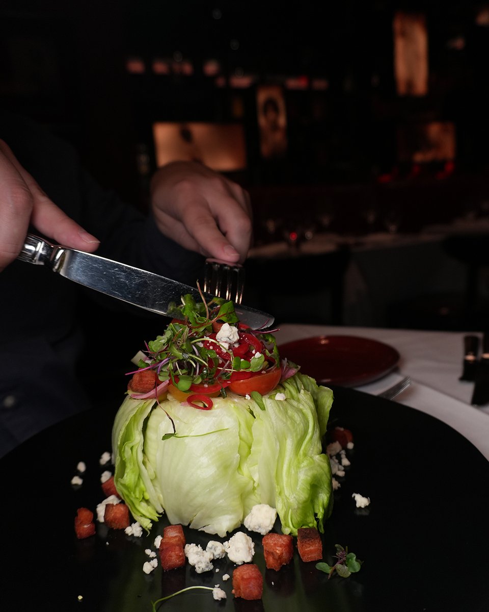 Kick things off with our Baby Iceberg Wedge — packed with heirloom cherry tomatoes, blue cheese crumbles, crispy bacon lardons, radish, pickled red onion, and a drizzle of blue cheese dressing. A refreshing start to your Strip House experience!✨