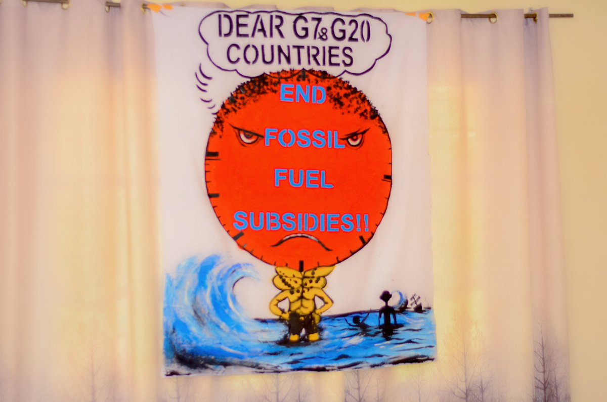 Participants of XR Green World Youth Rwanda listen to a presentation on fossil fuel subsidies before a peaceful protest.