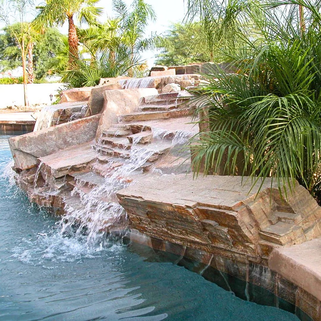 Make a splash this summer! ☀️🌊 Enhance your pool with a stunning water feature using Mt. Moriah Stone landscape boulders and flats.

 #palmsprings #outdooroasis #poolinspo #poolgoals