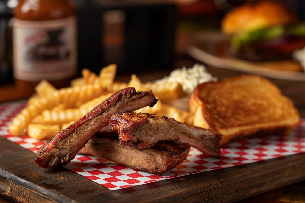 Spare Rib Lunch Special – Only $11.99!
Fall-off-the-bone hickory-smoked pork ribs, marinated in our signature BBQ sauce &amp; char-grilled to perfection.
Served with crispy fries, creamy coleslaw &amp; garlic bread.
Lunch just got 🄻🄴🄶🄴🄽🄳🄰🅁🅈. 
Available Weekdays from 11 AM - 4 PM