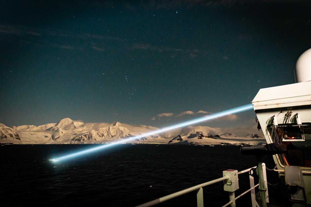 HMCS MARGARET BROOKE's crew operates the ship's searchlight while sailing off the coast of Rothera Research Station, Adelaide Island, Antarctica, during Operation PROJECTION 25-01 on 15 March 2025. #RCN