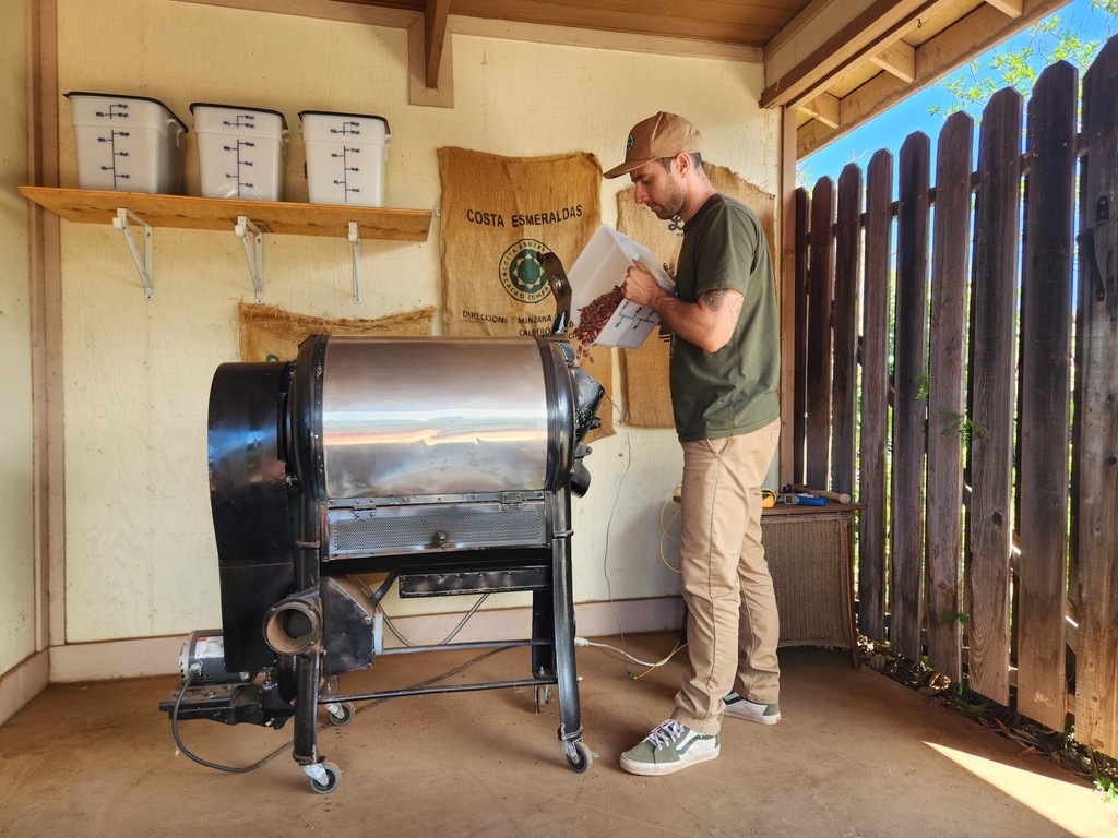 Valley Isle Chocolate’s co-founder and chocolate maker Sam Phillips loads the roaster. Cacao beans are roasted to bring out the unique flavor profile.