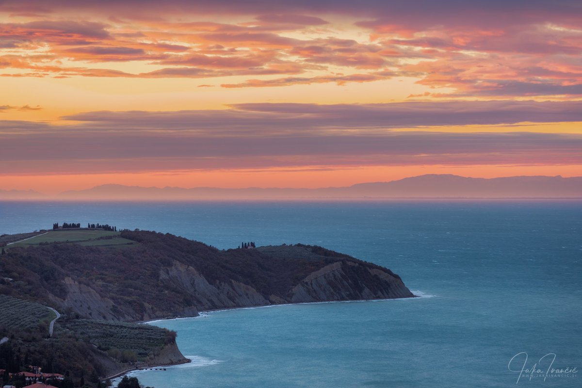 Ronek Cape with sunset colors and the Italian Alps in the distance, across the Adriatic Sea.  #istria #slovenia #ronekcape #izola #piran #ifeelslovenia #nature #landscape #alps #italy