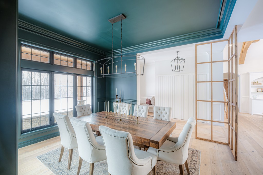 Bears Paw Project - This dining room strikes the perfect balance between rich wood tones and a bold blue accent wall. 

Interior Design: <a href="/rcid_/">Rochelle Cote</a>
Build: @wideskyhomes
Photo: @wideskyhomes