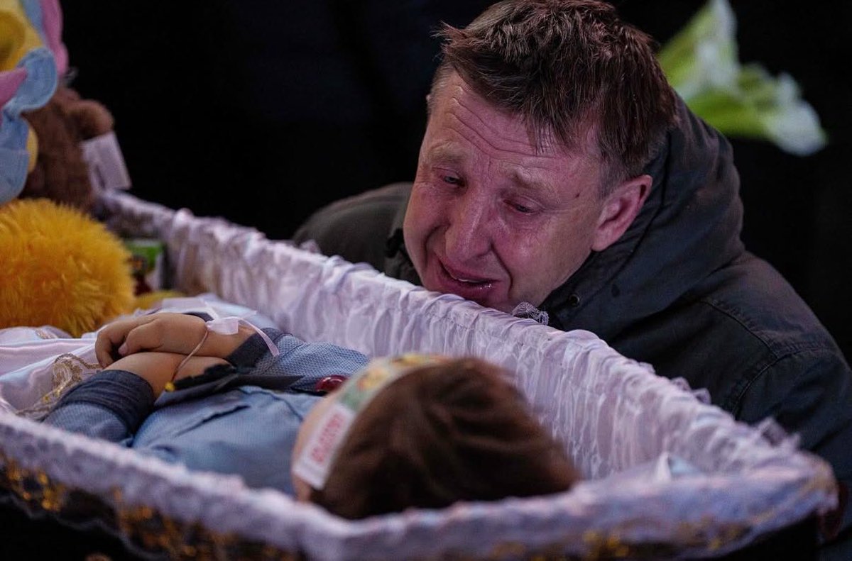 Photo from the funeral for a tiny victim of Russian terror. Evgeniy Maloletka. Ukraine. Kryvyi Rih.