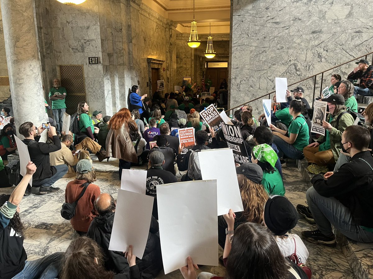 Shauna_Sowersby's tweet photo. Happening now: Washington state workers are sitting outside of Gov. Bob Ferguson’s office chanting, “come out, Bob!” The governor has proposed furlough days for state employees who bargained for a 5% pay increase last year. https://t.co/vCUczgDZOp