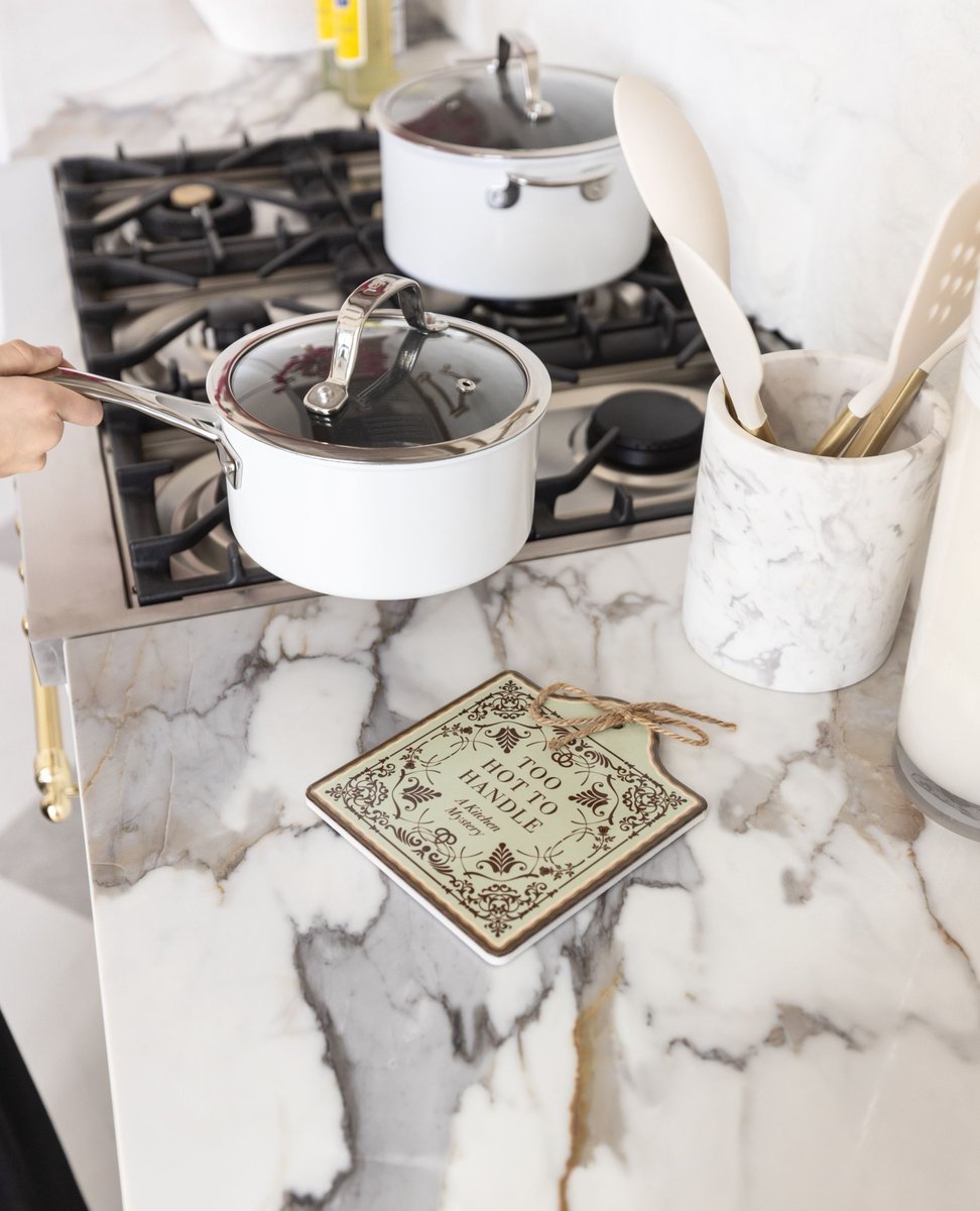 OUABookClub's tweet image. Experience a kitchen mystery with this next item from the Spring Boutique Collection - a ceramic trivet! This trivet measures 7.5" x 6.5" and will launch at $25. Don't forget - our Spring 2025 Boutique launch is happening this Friday, April 11th at 10am PT (1pm ET)! #OUABC