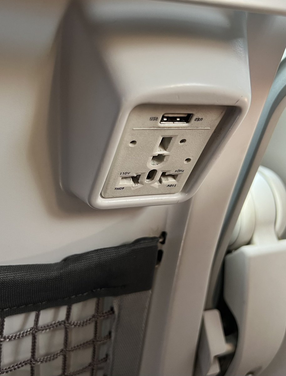 BStotch55's tweet photo. @BoeingAirplanes Hey Boeing (and seat suppliers) - Brilliant move to design your seats so that whatever you plug in to the always-worn-out outlet has to hang in an inverted orientation, ensuring it falls out.  Well done. https://t.co/9ZqJp8siJc