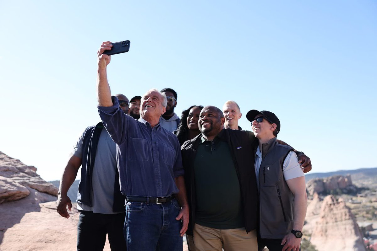 BuuVanNygren's tweet photo. SECRETARY OF HEALTH ROBERT F. KENNEDY JR. VISITS NAVAJO NATION

WINDOW ROCK, Ariz. — Against the backdrop of the iconic Window Rock arch, Navajo Nation President Buu Nygren sat on a sandstone cliff with U.S. Secretary of Health and Human Services Robert F. Kennedy Jr. and Council Delegate Germaine Simonson to discuss critical healthcare access issues facing the Navajo people—and the solutions rooted in sovereignty, tradition, and self-reliance.

Secretary Kennedy, on a national tour, made a significant stop on the Navajo Nation to meet with tribal leaders including President Nygren, First Lady Jasmine Blackwater-Nygren, Speaker Crystalyne Curley, members of the 25th Navajo Nation Council, and officials from the Navajo Department of Health. The purpose of the visit was to better understand how Navajo programs are maximizing federal resources to serve thousands of Navajo people across the Nation.

"I know that you're no stranger to Navajo," President Nygren told Secretary Kennedy. "With your support and help, we will build the Gallup Indian Medical Center because it is in such, such need. It will expand to where we do not have to go to Albuquerque or Phoenix and our people will have a world-class facility."

The visit was deeply personal for Secretary Kennedy, who last set foot on the Navajo Nation 60 years ago alongside his father. His return began with a sunrise hike with tribal leaders from the base of the tribal capital to Window Rock. They were met with sacred prayer, traditional songs by a medicine healer, and ceremonial dances performed by the Dinétah Dancers at the Navajo Veterans Memorial Park.

President Nygren provided additional context about the urgent health disparities on the Nation and the strain caused by the Indian Health Service’s 30 percent vacancy rate.

“As President, I want to emphasize the importance of protecting and maintaining tribal sovereignty among food and healthcare for the Navajo Nation,” President Nygren said.

Secretary Kennedy expressed strong support, making a clear commitment to address staffing shortages and cuts in the Indian Health Service.

“By lifting the IHS hiring freeze and rescinding the hundreds of employee terminations,” Secretary Kennedy said, “it will not happen.”

Secretary Kennedy emphasized that the federal government must go further to empower Native communities.

"Today we learned many things that HHS could be doing to improve the condition of Navajo health...,” he said, adding that securing water will allow the Navajo people to build homes and become self-sustaining again.

A focal point of Secretary Kennedy’s visit was the Navajo Nation’s pioneering of the junk food tax, formally known as the Healthy Diné Nation Act. Passed in 2014 through grassroots mobilization by the Diné Community Advocacy Alliance, the law promotes healthy lifestyles and combats rising rates of diabetes and obesity.

The Indian Health Service reports that one in five Navajo Nation residents lives with diabetes, and approximately 75,000 individuals are prediabetic.

Revenues from the junk food tax have been redirected to support community wellness projects through the Navajo Division of Community Development, according to the Office of the Navajo Tax Commission.

President Nygren also emphasized the need for formal tribal consultations to ensure that the trust and treaty responsibilities are upheld, especially as recent changes at the federal level have impacted social services.

“We strive to live for 102 years as Navajo people, and also with your help and assistance, we look forward to reestablishing and protecting some of the services that your department provides,” President Nygren told Secretary Kennedy.

President Nygren added, “Secretary Kennedy’s visit today shows that our voices are being heard at the highest levels. We’re not asking for charity, we’re reaffirming equity, and we’re building solutions grounded in sovereignty…the Navajo Nation is ready to lead.”