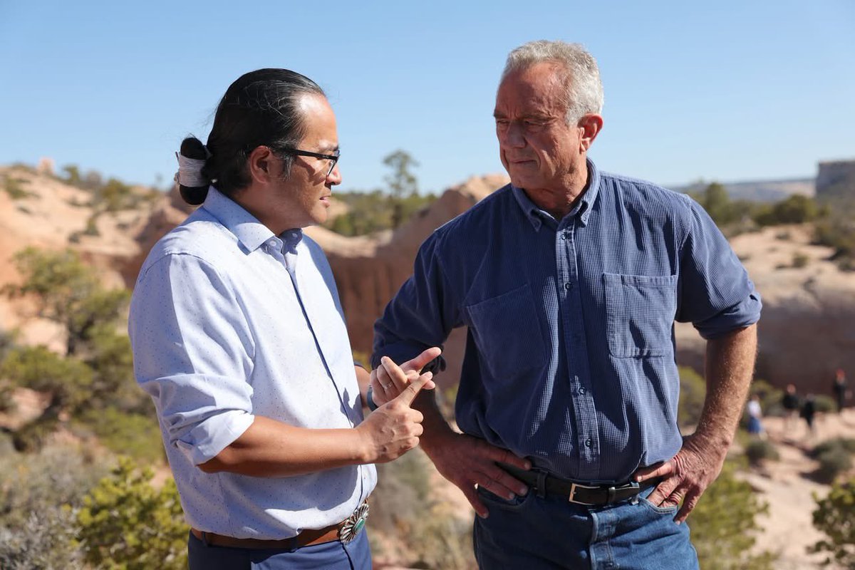 BuuVanNygren's tweet photo. SECRETARY OF HEALTH ROBERT F. KENNEDY JR. VISITS NAVAJO NATION

WINDOW ROCK, Ariz. — Against the backdrop of the iconic Window Rock arch, Navajo Nation President Buu Nygren sat on a sandstone cliff with U.S. Secretary of Health and Human Services Robert F. Kennedy Jr. and Council Delegate Germaine Simonson to discuss critical healthcare access issues facing the Navajo people—and the solutions rooted in sovereignty, tradition, and self-reliance.

Secretary Kennedy, on a national tour, made a significant stop on the Navajo Nation to meet with tribal leaders including President Nygren, First Lady Jasmine Blackwater-Nygren, Speaker Crystalyne Curley, members of the 25th Navajo Nation Council, and officials from the Navajo Department of Health. The purpose of the visit was to better understand how Navajo programs are maximizing federal resources to serve thousands of Navajo people across the Nation.

"I know that you're no stranger to Navajo," President Nygren told Secretary Kennedy. "With your support and help, we will build the Gallup Indian Medical Center because it is in such, such need. It will expand to where we do not have to go to Albuquerque or Phoenix and our people will have a world-class facility."

The visit was deeply personal for Secretary Kennedy, who last set foot on the Navajo Nation 60 years ago alongside his father. His return began with a sunrise hike with tribal leaders from the base of the tribal capital to Window Rock. They were met with sacred prayer, traditional songs by a medicine healer, and ceremonial dances performed by the Dinétah Dancers at the Navajo Veterans Memorial Park.

President Nygren provided additional context about the urgent health disparities on the Nation and the strain caused by the Indian Health Service’s 30 percent vacancy rate.

“As President, I want to emphasize the importance of protecting and maintaining tribal sovereignty among food and healthcare for the Navajo Nation,” President Nygren said.

Secretary Kennedy expressed strong support, making a clear commitment to address staffing shortages and cuts in the Indian Health Service.

“By lifting the IHS hiring freeze and rescinding the hundreds of employee terminations,” Secretary Kennedy said, “it will not happen.”

Secretary Kennedy emphasized that the federal government must go further to empower Native communities.

"Today we learned many things that HHS could be doing to improve the condition of Navajo health...,” he said, adding that securing water will allow the Navajo people to build homes and become self-sustaining again.

A focal point of Secretary Kennedy’s visit was the Navajo Nation’s pioneering of the junk food tax, formally known as the Healthy Diné Nation Act. Passed in 2014 through grassroots mobilization by the Diné Community Advocacy Alliance, the law promotes healthy lifestyles and combats rising rates of diabetes and obesity.

The Indian Health Service reports that one in five Navajo Nation residents lives with diabetes, and approximately 75,000 individuals are prediabetic.

Revenues from the junk food tax have been redirected to support community wellness projects through the Navajo Division of Community Development, according to the Office of the Navajo Tax Commission.

President Nygren also emphasized the need for formal tribal consultations to ensure that the trust and treaty responsibilities are upheld, especially as recent changes at the federal level have impacted social services.

“We strive to live for 102 years as Navajo people, and also with your help and assistance, we look forward to reestablishing and protecting some of the services that your department provides,” President Nygren told Secretary Kennedy.

President Nygren added, “Secretary Kennedy’s visit today shows that our voices are being heard at the highest levels. We’re not asking for charity, we’re reaffirming equity, and we’re building solutions grounded in sovereignty…the Navajo Nation is ready to lead.”