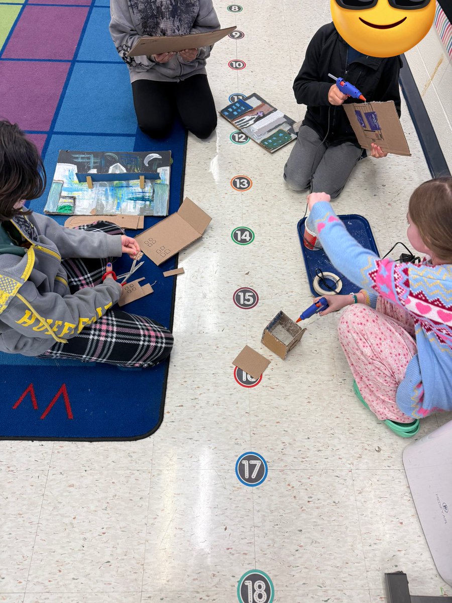 5th grade students creating low relief cardboard cityscapes
