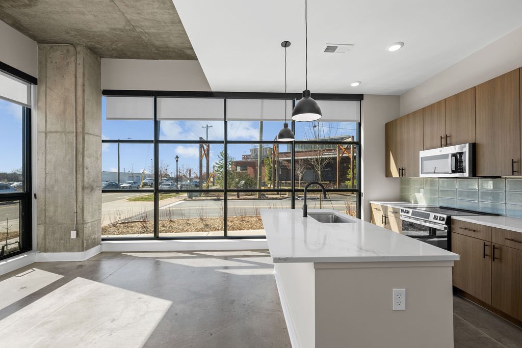 Our ground floor apartments got some special finishes!

Exposed concrete, high ceilings, huge windows