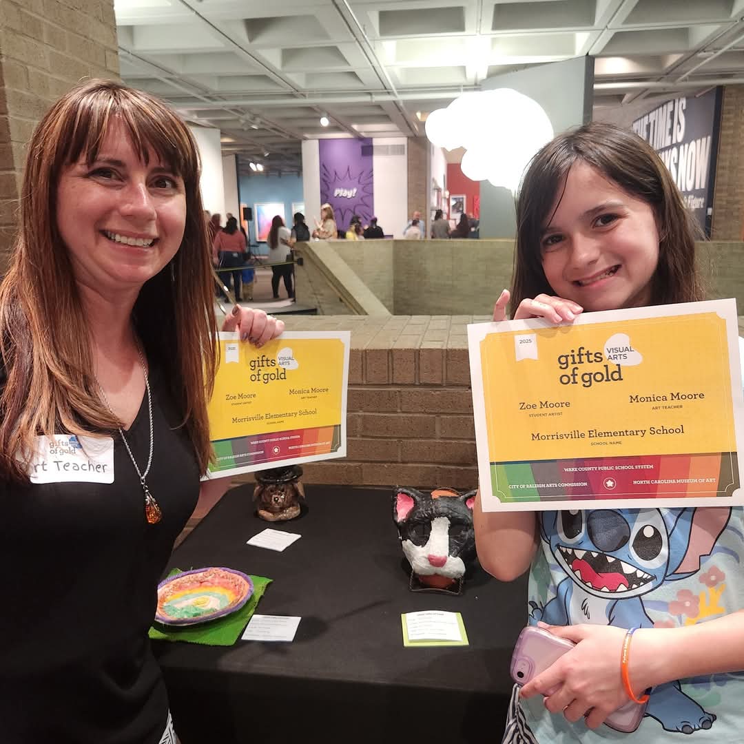 MrsMooreArt's tweet photo. Tonight was WCPSS's annual Gifts of Gold celebration at the NCMA, where Zoe's plaster cat mask is on display. It was so fun to see the amazing artwork from all over the county. https://t.co/UifIzRCkA8