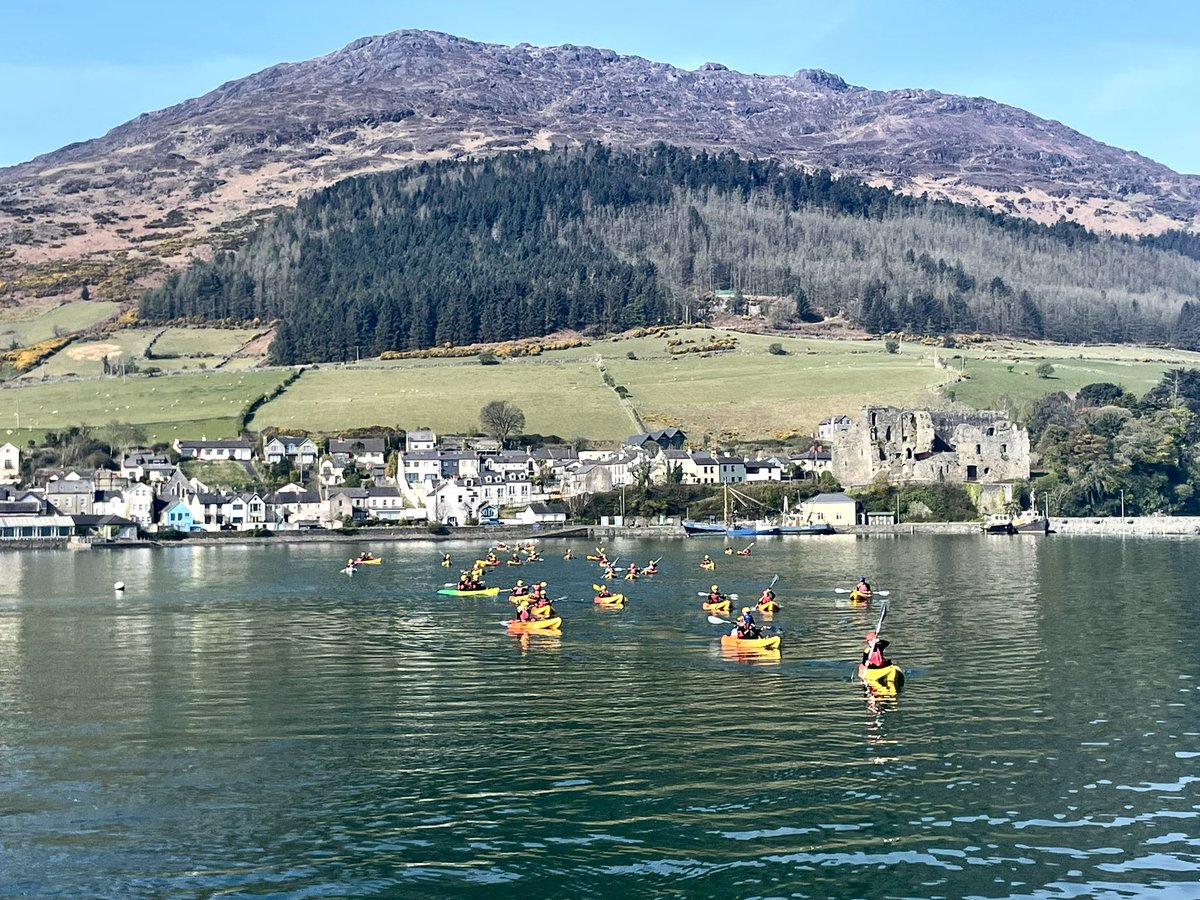 Colourful Kayakers enjoying a clam water under Slieve Foy