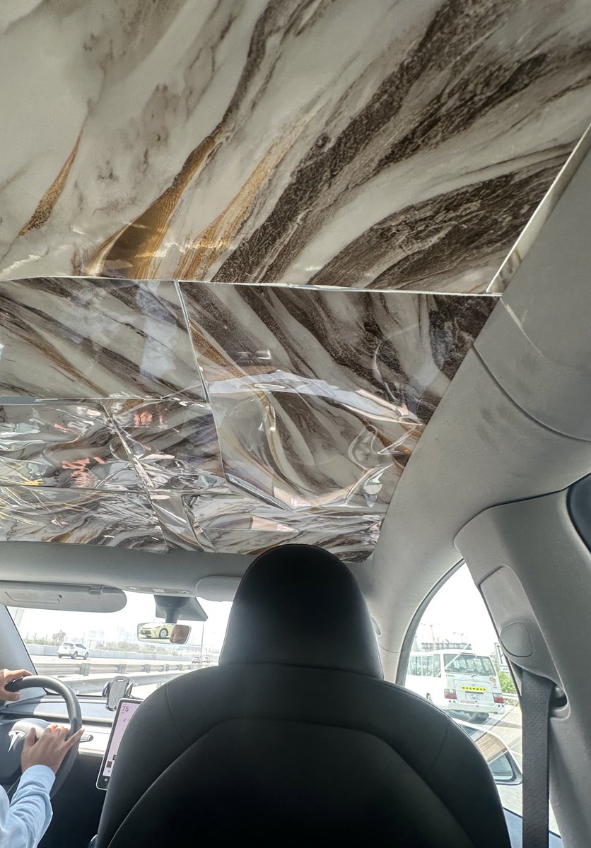 Cbeul1's tweet photo. @Tesla @elonmusk Ubers in Dubai are getting out of hand. There must be a better solution for sun protection ☀️ 😂 https://t.co/MXRuq8JDD8
