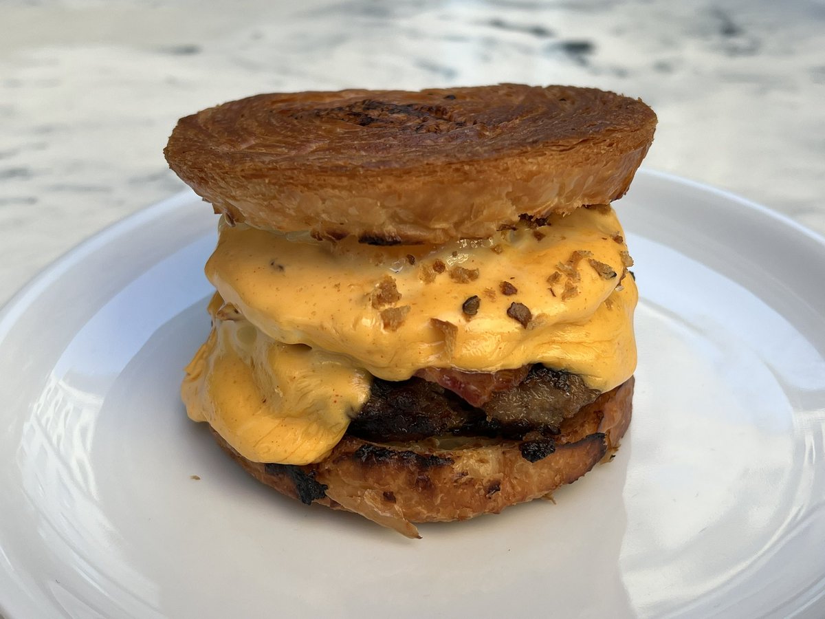 Last breakfast in London (for now): The Royale with Cheese at Fallow - sausage patty, cheese, bacon, and fried egg on a crisp and extra buttery croissant bun ($21).