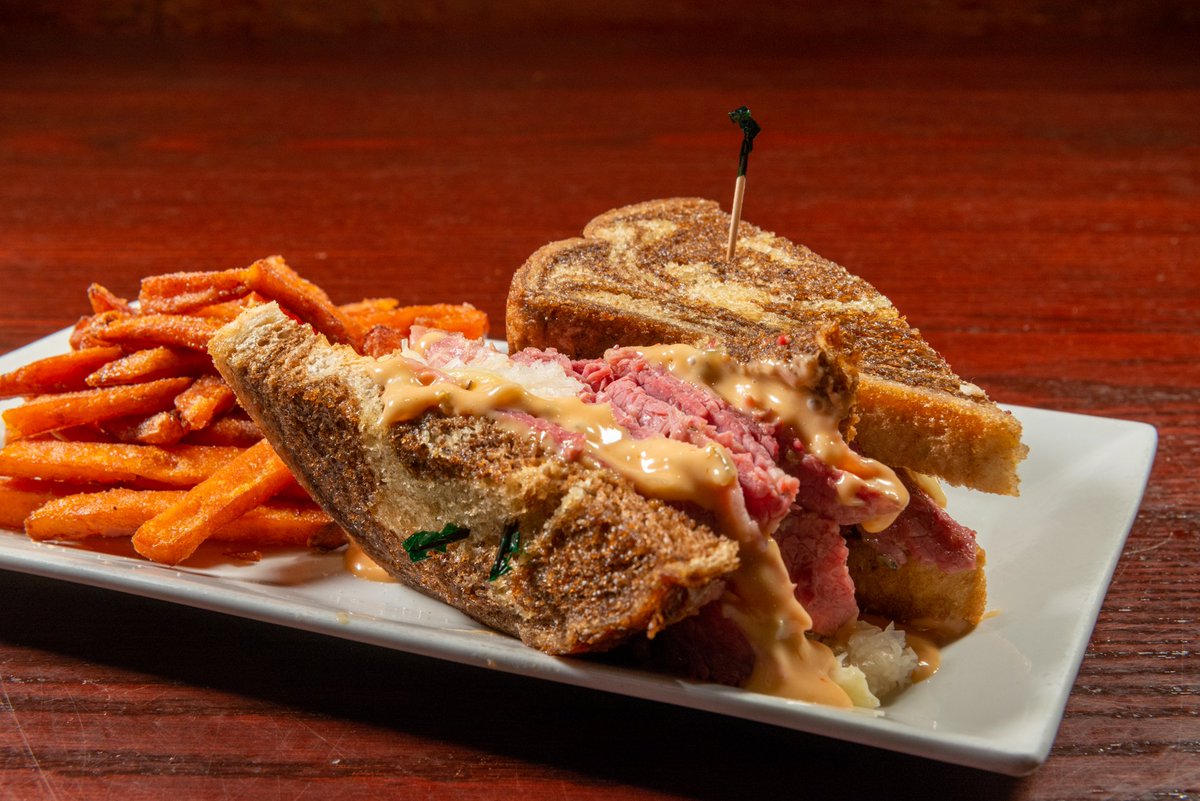 People can't stop talking about our Reuben — Thinly sliced corned beef marinated all day, slice of Swiss cheese, 1000 Island dressing, sauerkraut, served on your choice of marbled rye or pretzel roll.