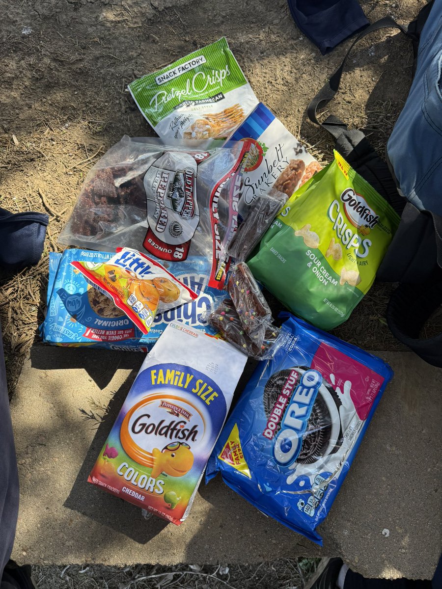 T_Sharp_'s tweet photo. 2 teenage boy throwers meet day snacks. 

The jerky is a solid choice… the rest 😬 

*Not pictured the family size bag of chips that didn’t survive the bus ride. 

#snacksonsnacks https://t.co/T7Kafg0CQt