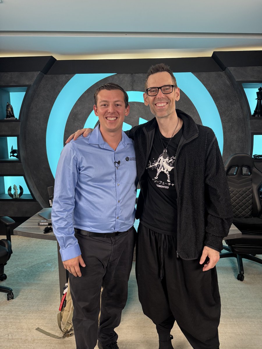 CorporateStrea1's tweet photo. Smiling with my mentor @TomBilyeu in front of the Impact Theory logo—a symbol of growth and grit. Tom, your work has transformed me as a person and entrepreneur. Grateful for the tour, the pics, and the chance to see your mission up close. https://t.co/sHDLL9sXtT