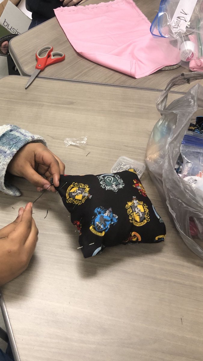Such a treat teaching a group of middle school students how to sew by hand. One student about to slip stitch and finish her first project.