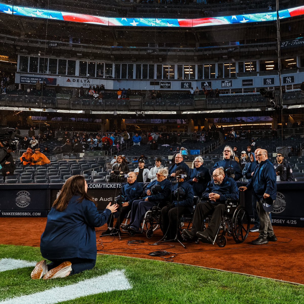 Yankees's tweet photo. In recognition of World Parkinson’s Day, we were honored to have The ParkinSINGS Choir for tonight’s beautiful rendition of our National Anthem!

In collaboration with the @HMHNewJersey, @JFKJohnson & @ParkinsonDotOrg, the group, comprised of members with Parkinson’s disease & Parkinson-Plus syndromes, meets weekly to rehearse songs to maintain strength in their speech & vocal muscles.