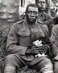 A member of the Harlem Hellfighters, which were an all-Black infantry unit in WWI (1914-1918) who spent more time in combat than any previous other American unit.