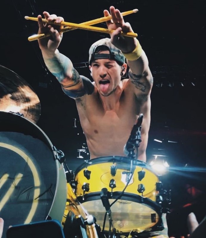 Hellooo! Please help! I'm looking for a picture of josh looking through his drumsticks. It's a front angle pic and he's making a fun expression. It's a mix between the 2 on the post. I've seen the picture before I just can't find it anywhere now