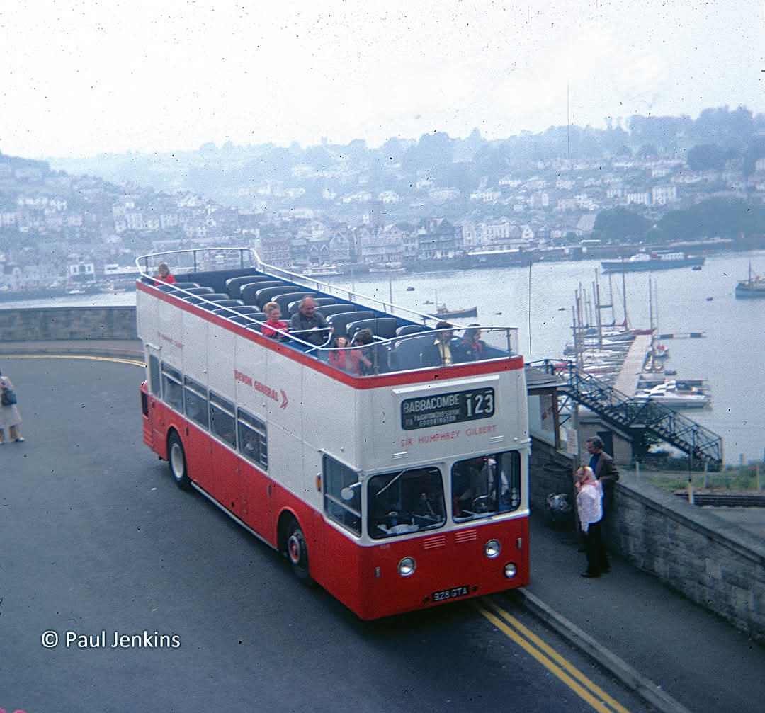 1961 'Sea Dog' convertible open-top Leyland Atlantean 928 GTA 'Sir Humphrey Gilbert' is seen at Kingswear in June 1977. The use of side route boards for the open-top services had been discontinued by this time.
Picture credit: Paul Jenkins