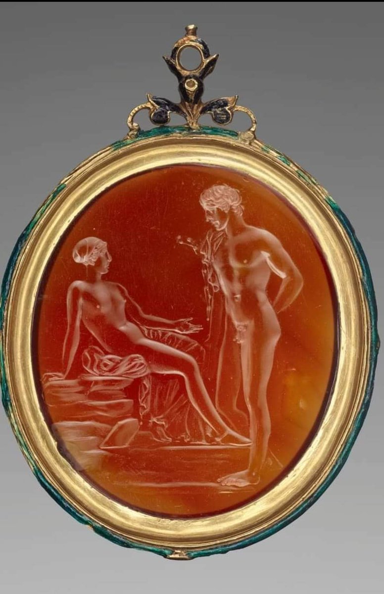 archeohistories's tweet image. Roman (Carnelian) Gem engraved with Venus and Anchises (25 BC), set in a modern gold and enamel setting, from Rome - Italy. 

Superbly engraved, the gem depicts a woman, mostly naked, with her hair tied in a sakkos, sitting on a pile of stones, beckoning to a naked young man…