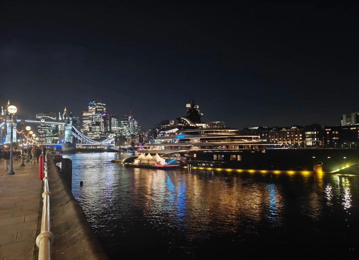 The city skyline illuminated by night casts a mesmerizing reflection on the water, 🌉✨