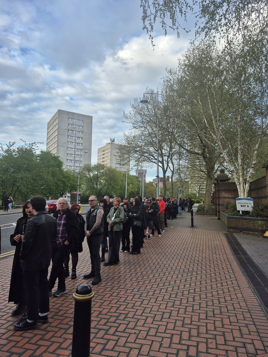 Bozzers's tweet photo. Holy shit. The queue to get in to @thebandGHOST at @UtilitaArenaBHM reaches up to the Library of Birmingham and as far as the eye can see every direction. I have never seen anything like this before in my whole life of coming to gigs in town 🤯 https://t.co/Sr1RHXtwFY