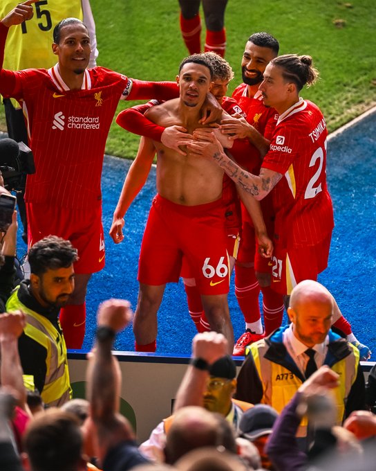 Trent Alexander-Arnold and the liverpool team celebrate with the away end after scoring against Leicester City in the Premier League