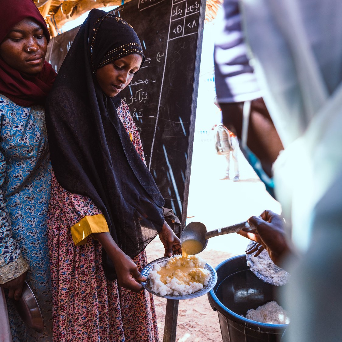 WVSudan's tweet photo. At 14, Saba fled Sudan with her family, leaving behind conflict and her father. In Chad, she shares her school meal with 9 others. “We don’t want children to be born here to see the conflict continue.” Her dream? A future with peace, learning, &amp; connection.
#SudanCrisis #2YearsOn https://t.co/0P3y1MwxlQ