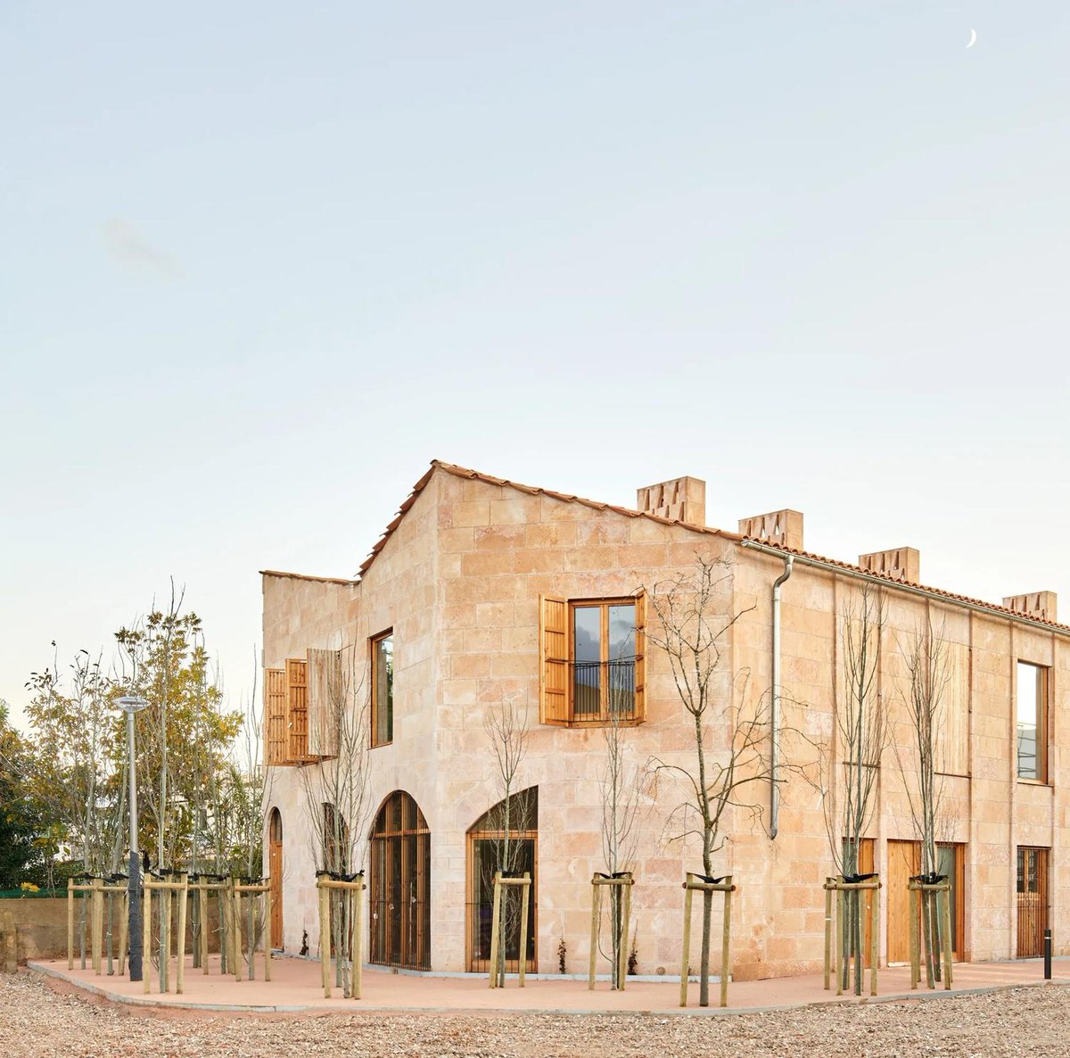 One of my favorite apartment buildings I've come across in some time. Warm, earthy, strong natural materials, and eminently welcoming.

The most surprising part? It's public housing!