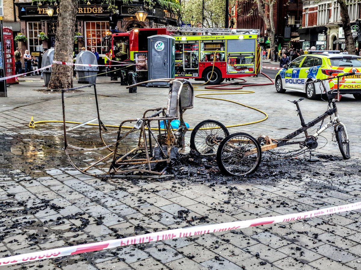 MDKtm's tweet photo. @sohosocietyw1 Pedicab on fire in front of Harry Potter on Cambridge Circus, Saturday afternoon. https://t.co/UfeejxSgtU