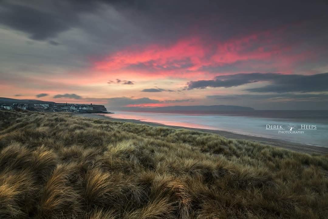 A rather lovely subtle sunset from the Dunes at Castlerock on the North Coast. 
Beautiful pink tones on the underside of the clouds reflected into the sea.
