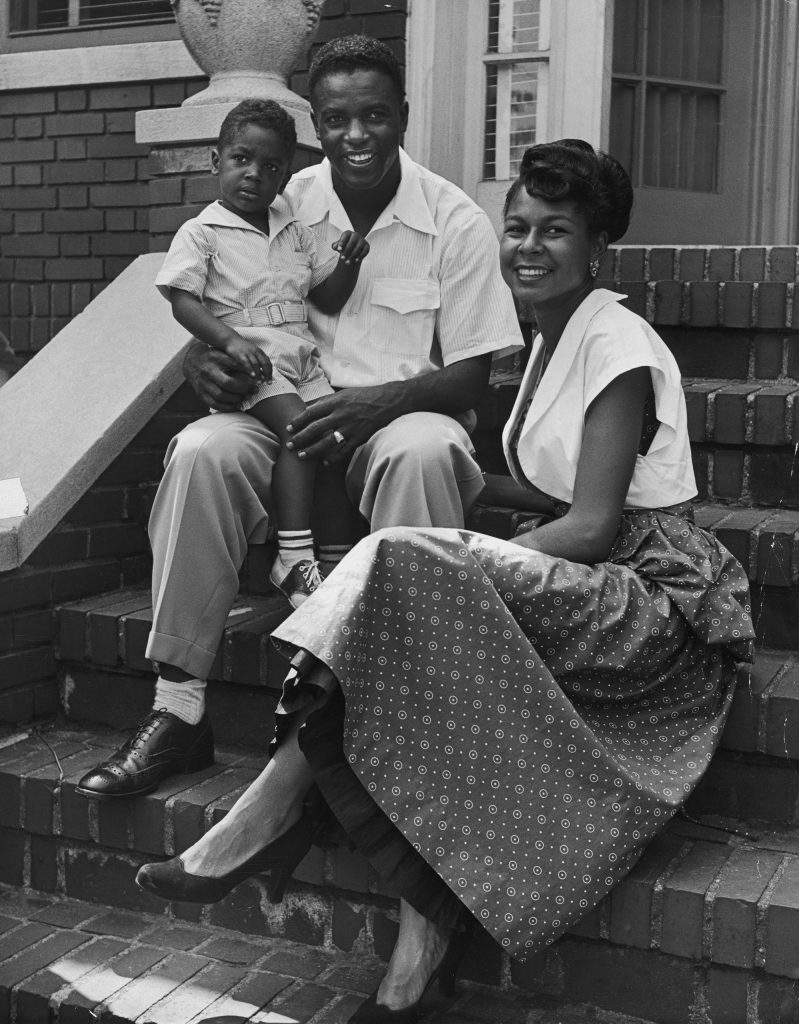 BBGreatMoments's tweet image. Jackie Robinson held his son, Jackie Jr., as he sat with his wife Rachel on the front steps of their home in 1949.