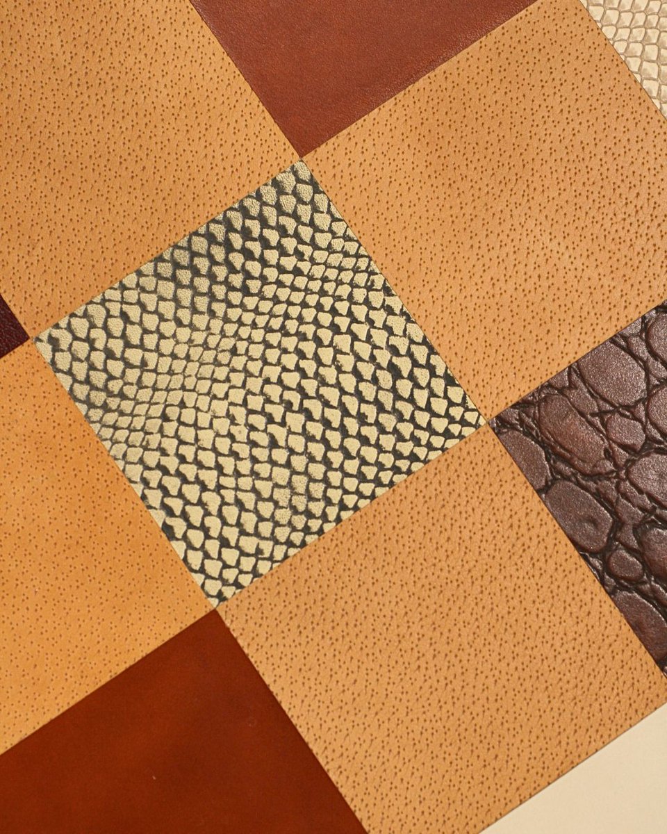 The maker’s love for wood was too strong to stain or dye it -  but how could a colourful, mosaic tabletop be created? The answer: leather. A wide variety of leathers were used, cut into tile-like shapes to form a vibrant surface!, which delights both the eye and the touch!🧩 👇