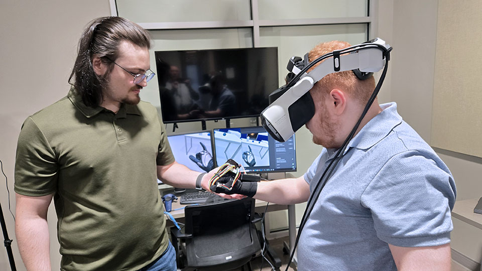 fiu_ece's tweet photo. 👏 Big shoutout to FIU grad students Julian Guerra &amp; Brad Alvarez for showcasing a haptic glove demo at Y-12! Their innovation in robotics, led by Dr. Bhansali &amp; Dr. Kamat, is shaping the future of safety training. 🤖 #FIUEngineering #MSIPP #Y12 #InnovationInAction https://t.co/7OPwYCHVDb